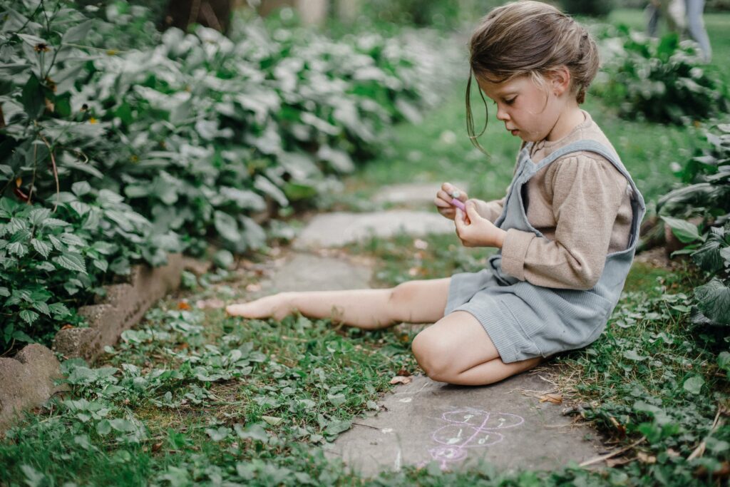 Child with chalk on stepping stones
