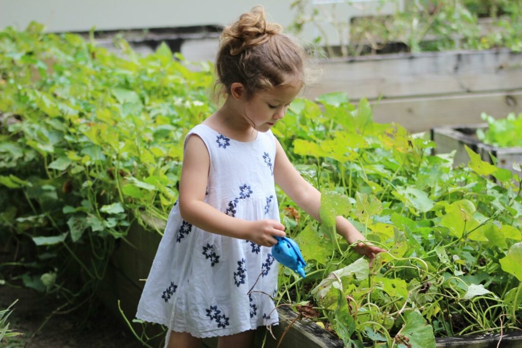 young girl holding watering can